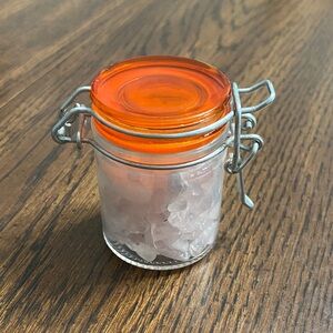 “5/$20” glass jar full of rose quartz crystal chips